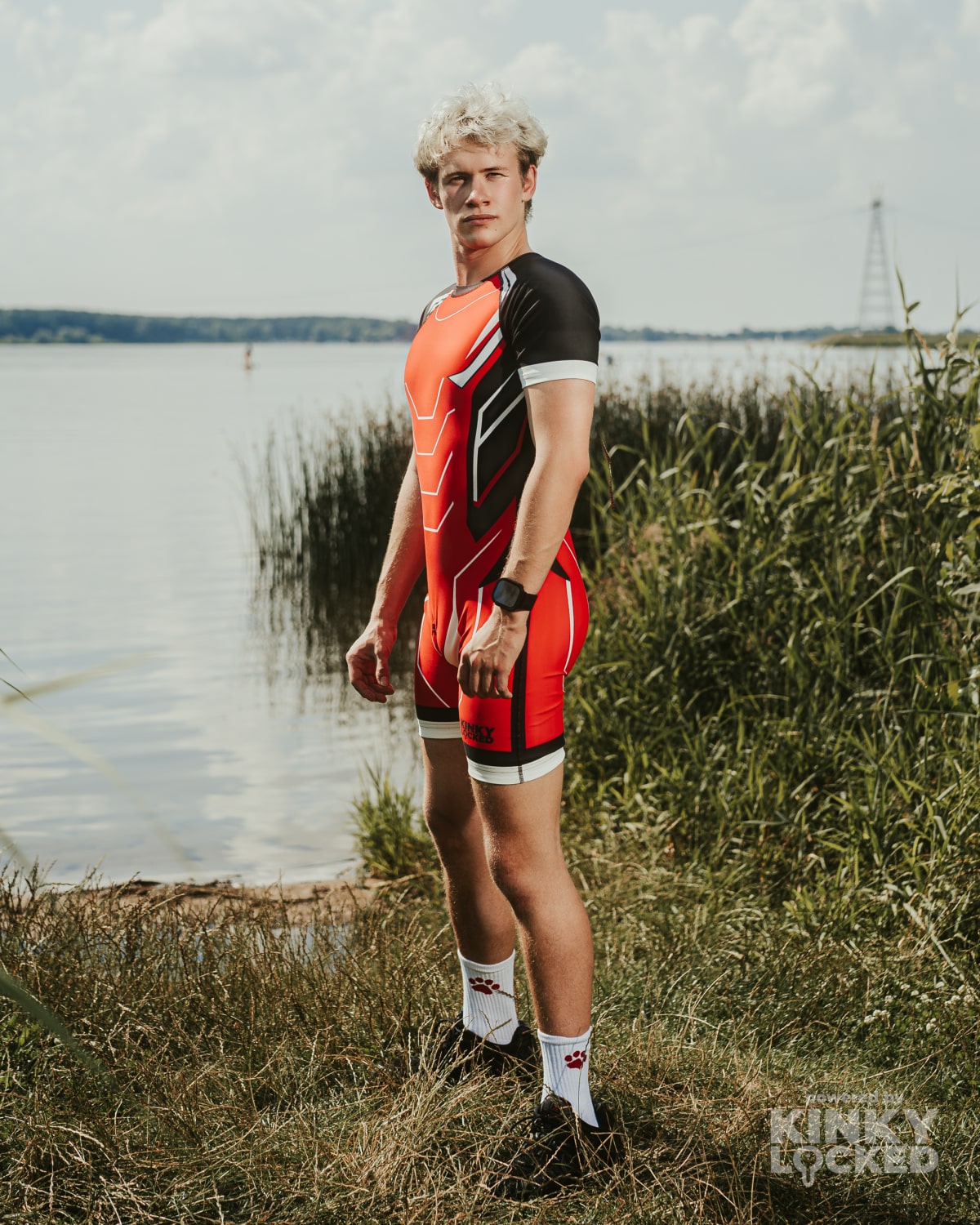 Side athletic view of the KINKY LOCKED Bold Red Surfsuit