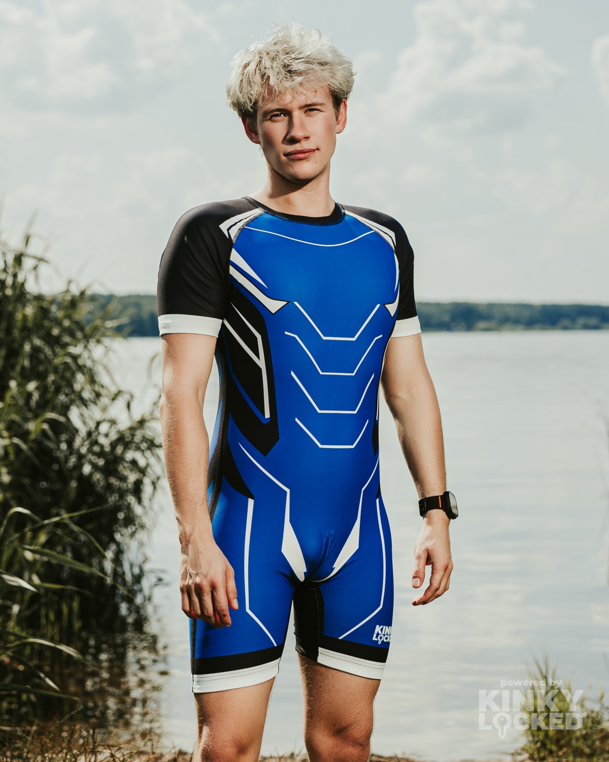 Front view of KINKY LOCKED Midnight Blue Surfsuit by the water