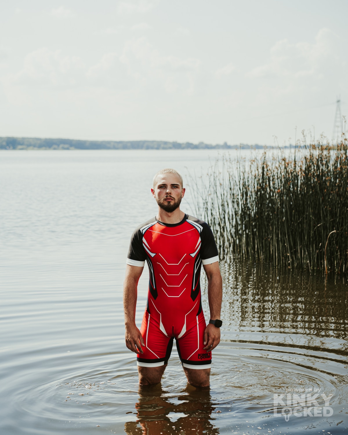 KINKY LOCKED Bold Red Surfsuit standing in the water