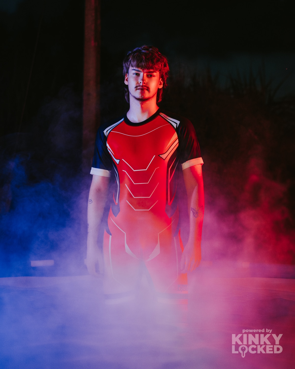 KINKY LOCKED Bold Red Surfsuit in dramatic red and blue light