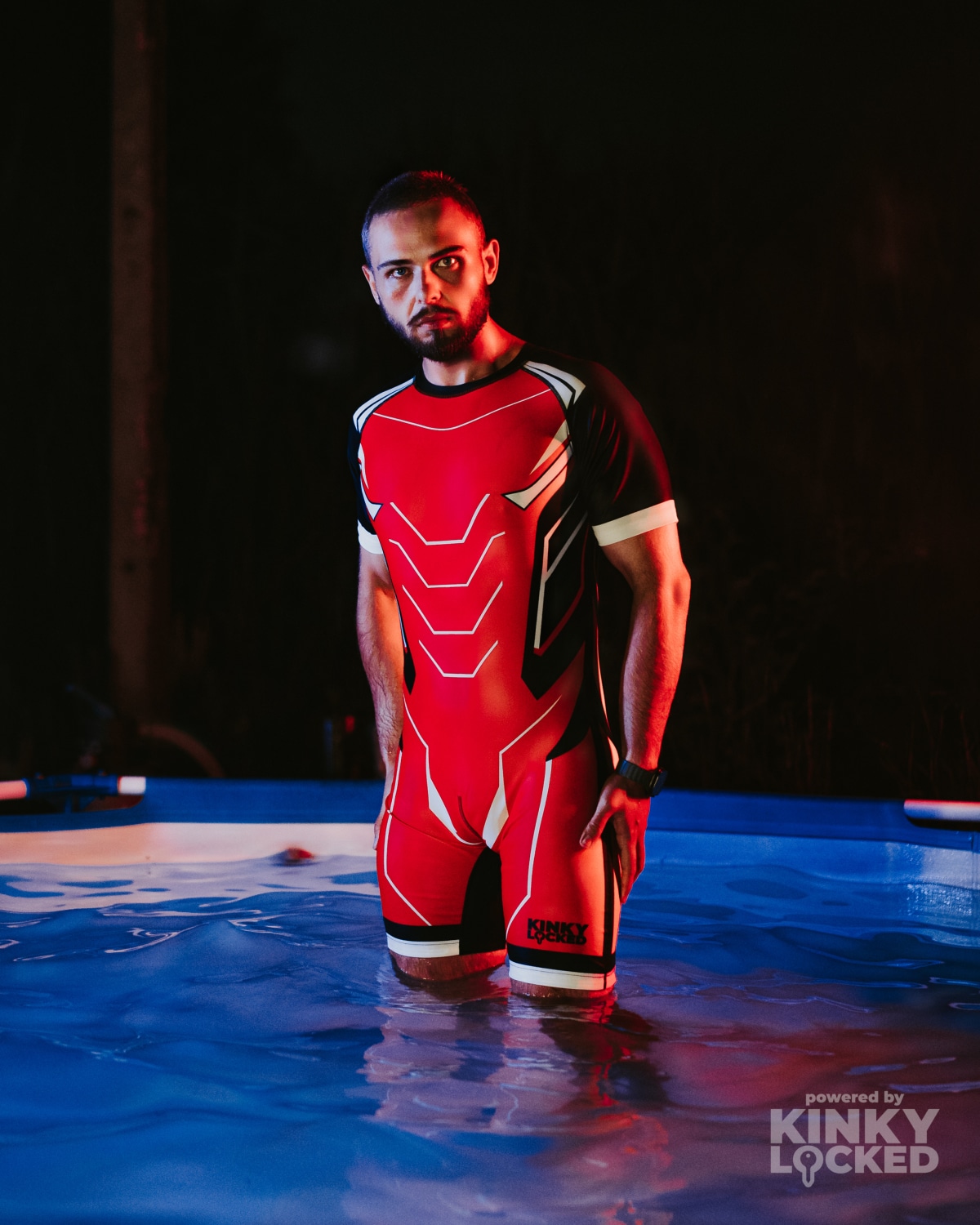Bold Red KINKY LOCKED Surfsuit in a dramatic poolside setting