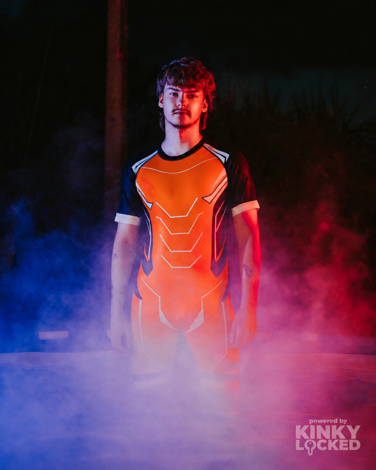 KINKY LOCKED Neon Orange Surfsuit in dramatic red and blue smoke